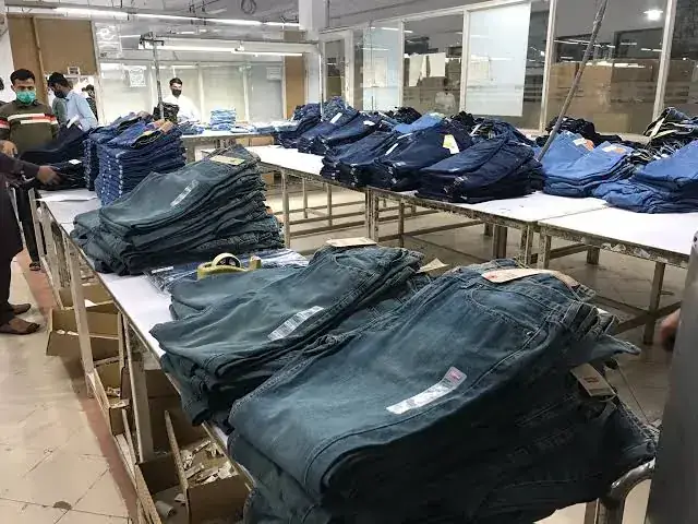 Jeans being folded and checked at a garment factory
