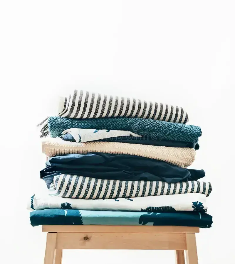 Stack of folded throws, blankets and bed linen