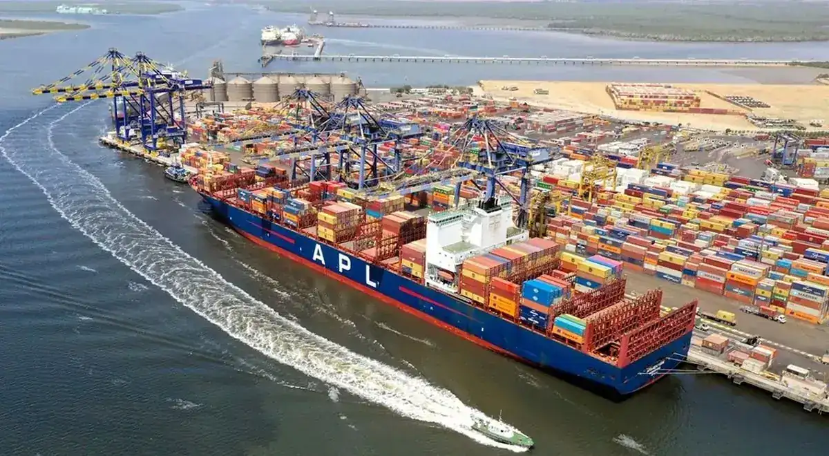 Container ship leaving a busy port