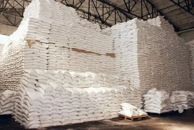 Large stacks of white sacks in a warehouse
