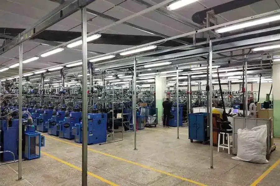 Rows of sock knitting machines in a factory